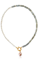 Necklace with pearls and green stones on a white background