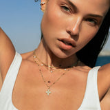 Woman with jewelry outdoors against a blue sky